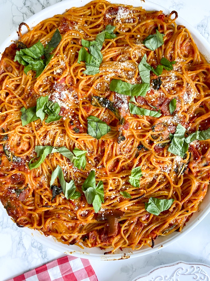 spicy spaghetti pie with fresh basil on top