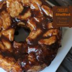 A close up of a doughnut on a plate, with Bread and Chocolate