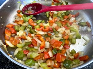 bell peppers, onions and garlic in frying pan