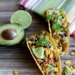 chicken avocado tacos on wooden board