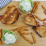 patty melt on a wooden cutting board