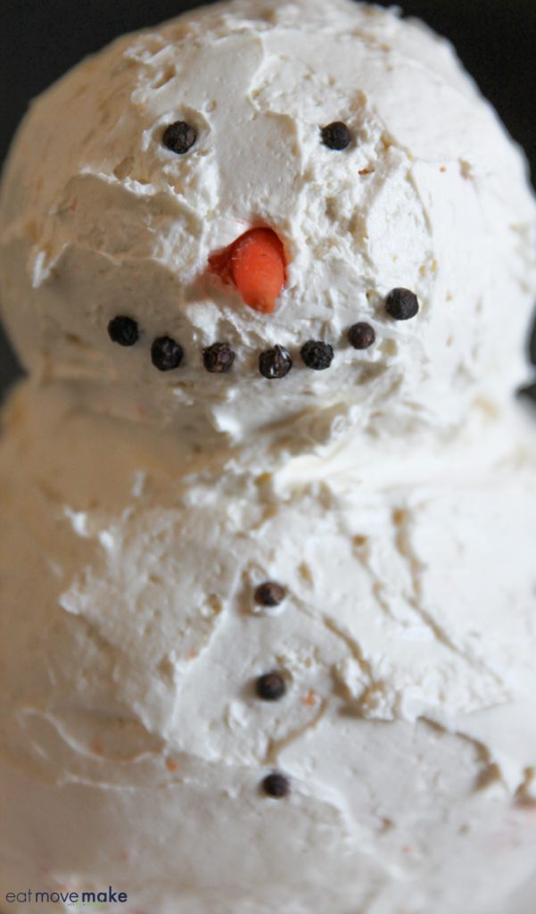 putting face on snowman cheese ball