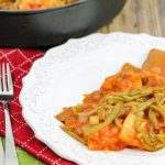 A bowl of food on a plate, with round Steak
