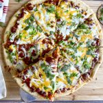 lifting slice of chili pizza