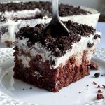 oreo poke cake on plate with fork