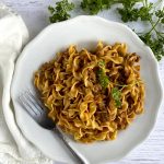 ground beef stroganoff on white plate with fork