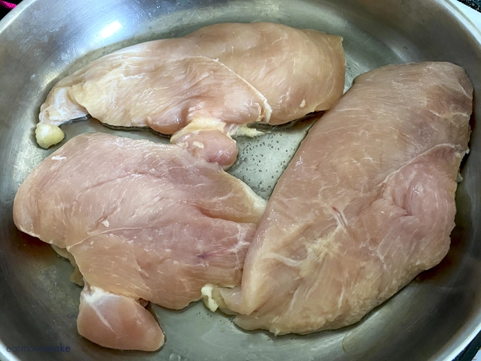 chicken cooking in frying pan