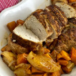 white serving dish with pork slices, apples and sweet potatoes