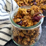 small jar of pumpkin seed granola by striped linen