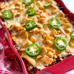 frito pie casserole in red dish on table