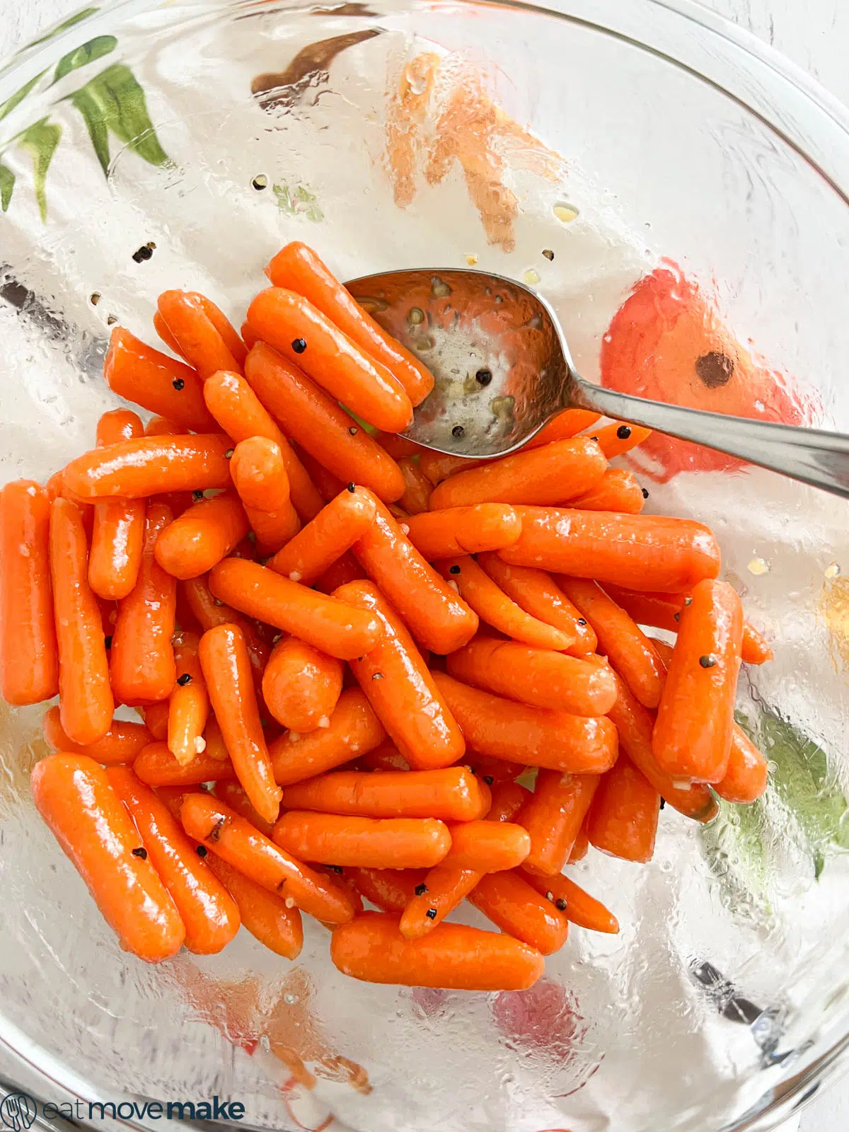 glazed carrots in bowl with spoon