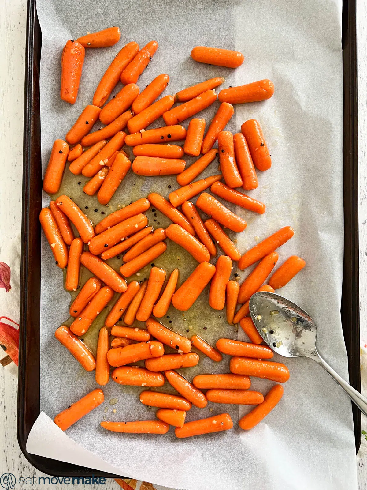 honey glazed baby carrots on parchment paper sheet