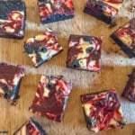 red velvet cheesecake brownies on wooden board.